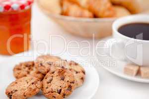 Cookies and a cup of coffee on white plates with sugar croissant
