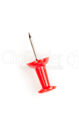 Close up of a red pushpin on the floor