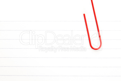 White paper with a red paperclip