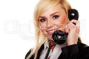 Woman talking on a telephone handset