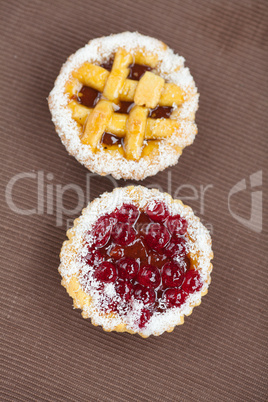 beautiful cake with berries on brown mat