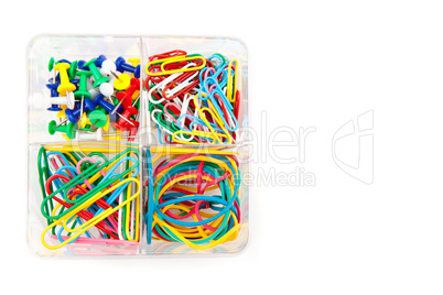 Box with multicolored of pushpins and paperclips