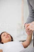 Physiotherapist holding a painful hand