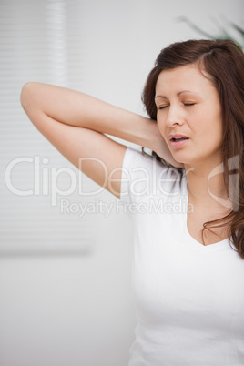 Woman touching her painful neck