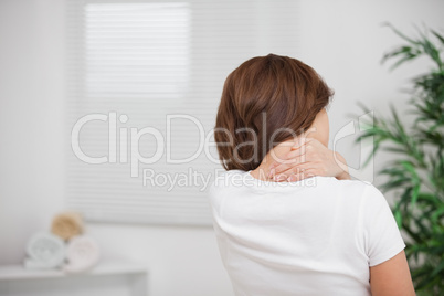 Woman massaging her painful nape