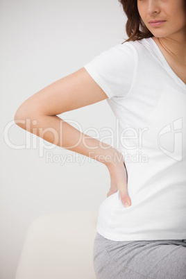 Woman massaging her painful hip while sitting