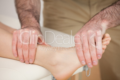Man massaging the foot of a woman