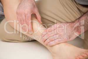 Physiotherapist massaging the shin bone
