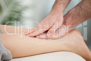 Physiotherapist massaging the calf of a woman