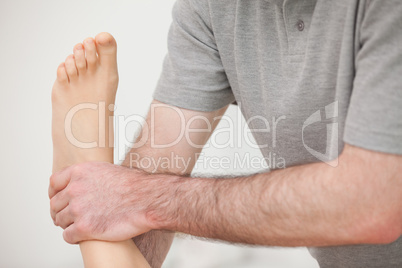 Close-up of a physiotherapist manipulating an ankle