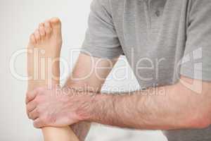 Close-up of a physiotherapist manipulating an ankle