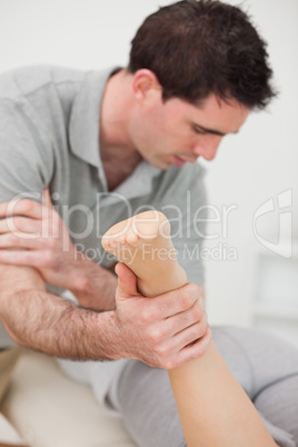 Chiropractor massaging a patient with his elbow