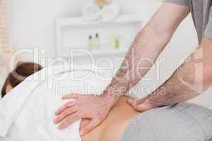 Masseur massaging the back of a woman