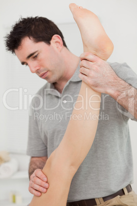 Chiropractor extending the leg of a patient