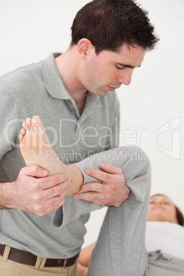 Woman lying on a table while being manipulated