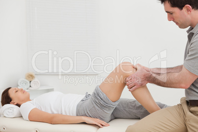 Man massaging the knee of a woman while sitting