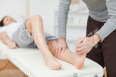 Physiotherapist stretching a barefoot