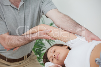 Woman being stretched while lying on a table