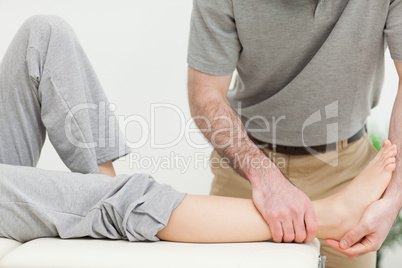 Close up on a doctor examining the foot of a woman