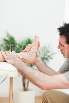 Close up of a physiotherapist massaging a foot