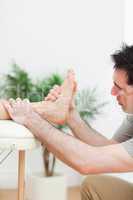 Close up of a physiotherapist massaging a foot