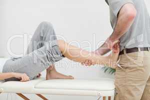 Close-up of a physiotherapist stretching the foot of a patient