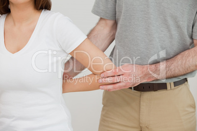 Close-up of a doctor examining the arm of a patient