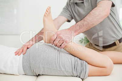 Close-up of a woman lying while being stretched