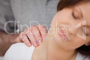 Close-up of a woman being massaged by a physiotherapist
