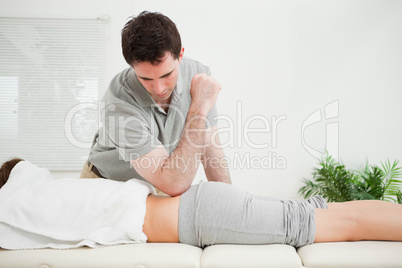 Man pressing the back of a woman with his elbow