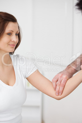 Close-up of a smiling woman being examined by a doctor