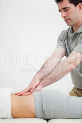 Close-up of a masseur massaging the back of a woman