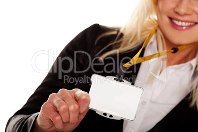 Businesswoman holding up her blank ID tag