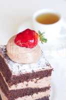 beautiful cake with strawberry and tea on a white background