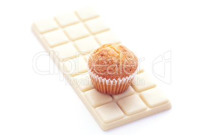 bar of white chocolate and muffin isolated on white