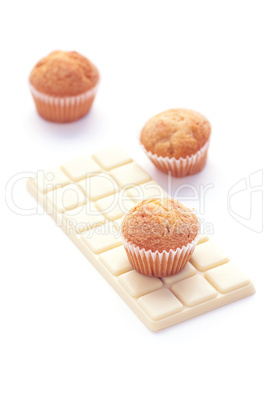 bar of white chocolate and muffin isolated on white