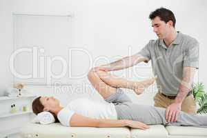 Woman lying on her back while being stretched