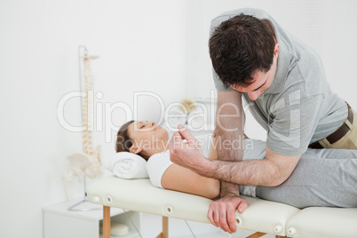 Physiotherapist massaging the pelvis of a woman