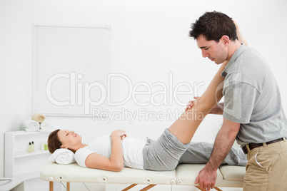 Man massaging a leg while placing it on his shoulder