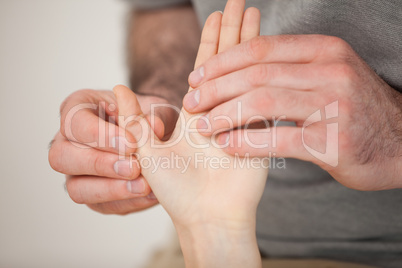 Thumb being massaged by a doctor