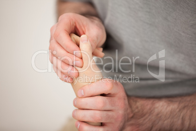 Doctor manipulating the fingers of a patient