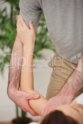 Brunette woman being manipulated by a doctor