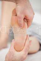 Doctor pressing his thumb on a foot
