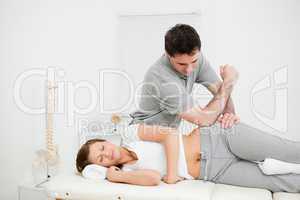 Doctor using his elbow to massage the hip of a woman