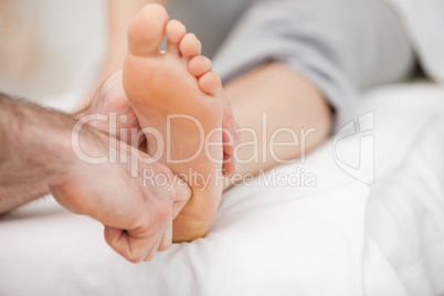 Ball of a foot being touched by a doctor