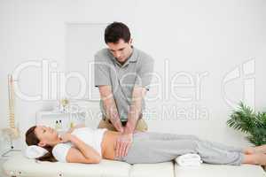 Peaceful woman being touched by an osteopath