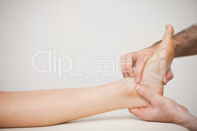 Doctor placing his fingers on the foot of a patient