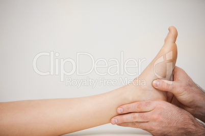 Chiropodist examining the foot of a patient