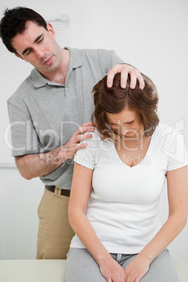 Physiotherapist moving the head of a patient