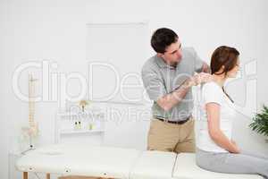 Physiotherapist massaging a brunette woman